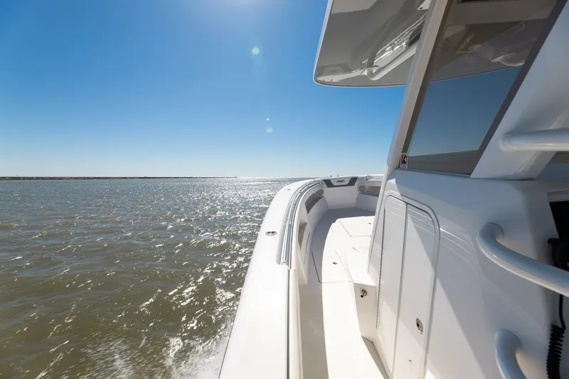  Yacht Photos Pics 2019 Invincible 39 Open Fisherman boat cruising on sunny waters.