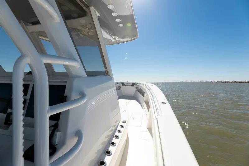  Yacht Photos Pics 2019 Invincible 39 Open Fisherman boat cruising on open water under clear blue sky.
