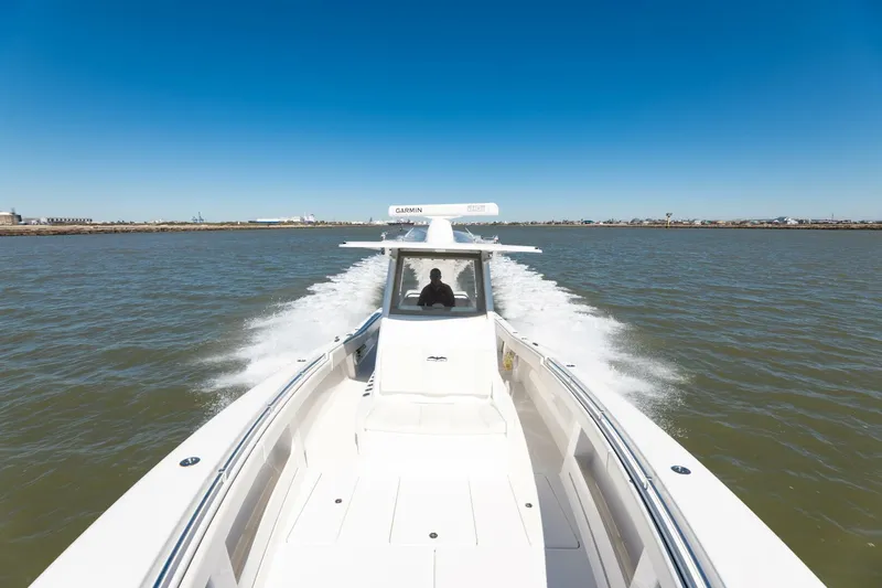  Yacht Photos Pics 2019 Invincible 39 Open Fisherman speeding on open water under clear blue sky.
