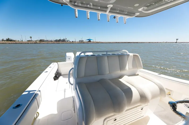  Yacht Photos Pics 2019 Invincible 39 Open Fisherman boat interior with cushioned seating, on calm water.