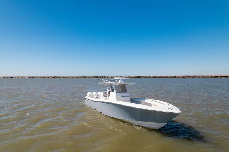 Yacht Photos Pics 2019 Invincible 39 Open Fisherman boat on calm waters under clear blue sky.