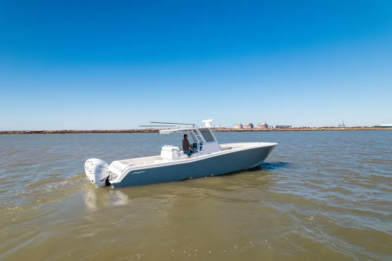  Yacht Photos Pics 2019 Invincible 39 Open Fisherman boat on calm water under clear blue sky.