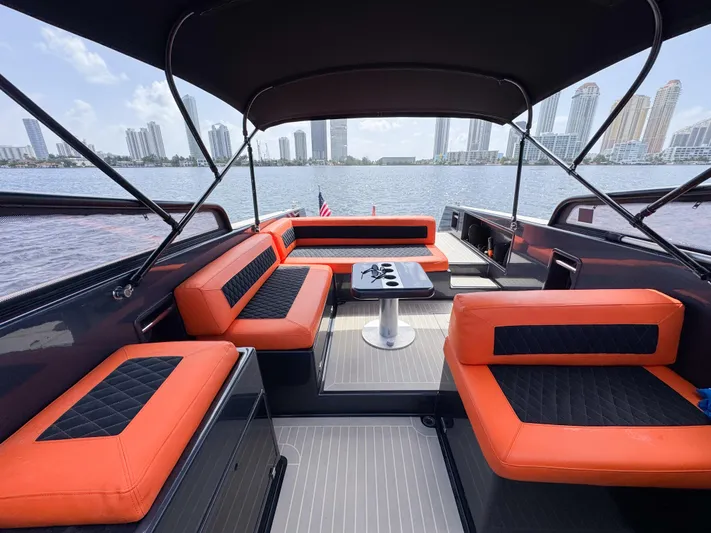  Yacht Photos Pics Luxurious 2016 VanDutch 30 yacht interior with orange seating, city skyline view.