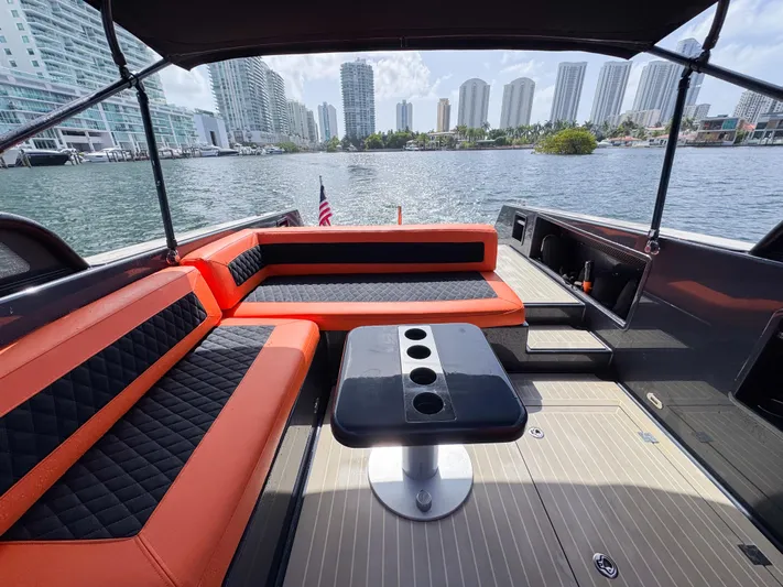  Yacht Photos Pics Luxurious 2016 VanDutch 30 yacht interior with orange and black seating, city skyline view.