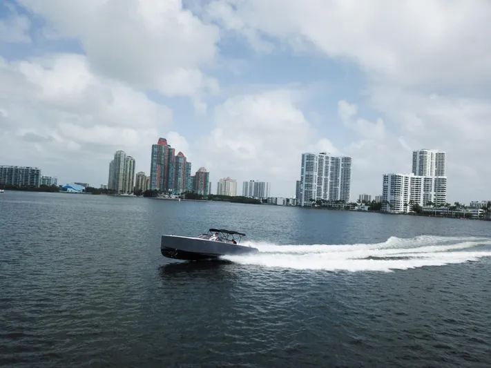  Yacht Photos Pics VanDutch 30 boat cruising on water with city skyline in background, 2016 model.