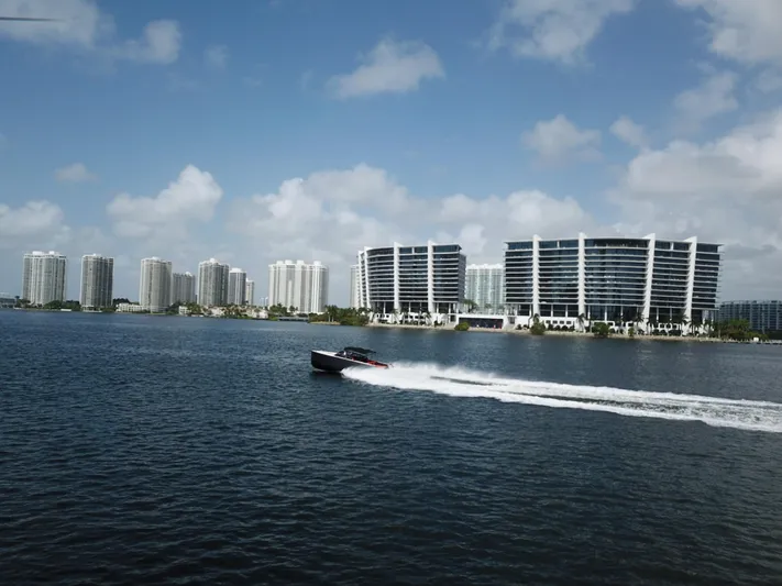  Yacht Photos Pics VanDutch 30 boat cruising on water with city skyline in background, 2016 model.