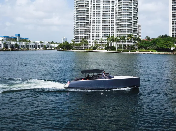  Yacht Photos Pics 2016 VanDutch 30 yacht cruising on a sunny day near waterfront buildings.