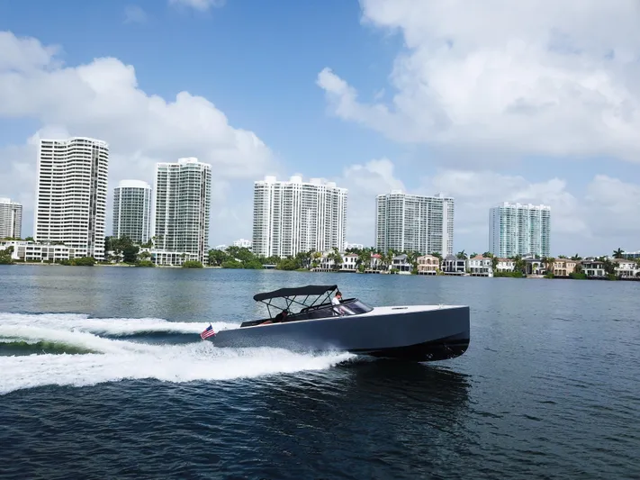  Yacht Photos Pics 2016 VanDutch 30 yacht cruising on water with city skyline in background.