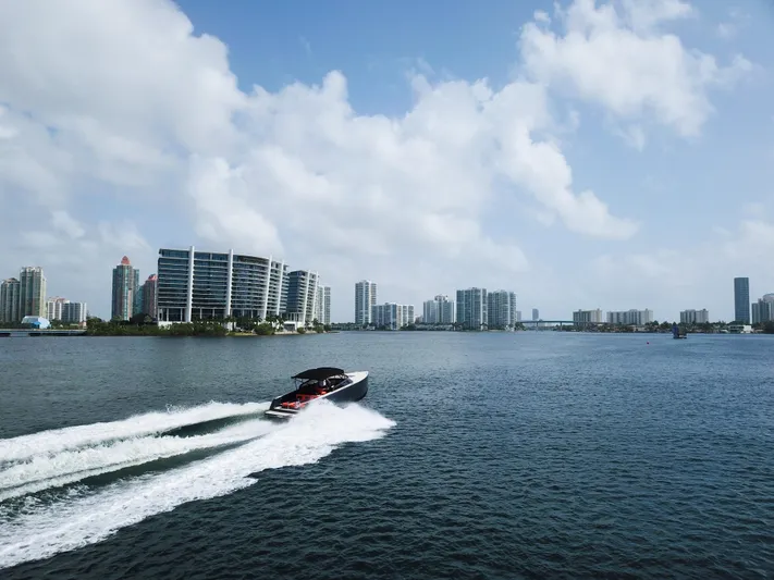  Yacht Photos Pics 2016 VanDutch 30 yacht cruising on water with city skyline in background.
