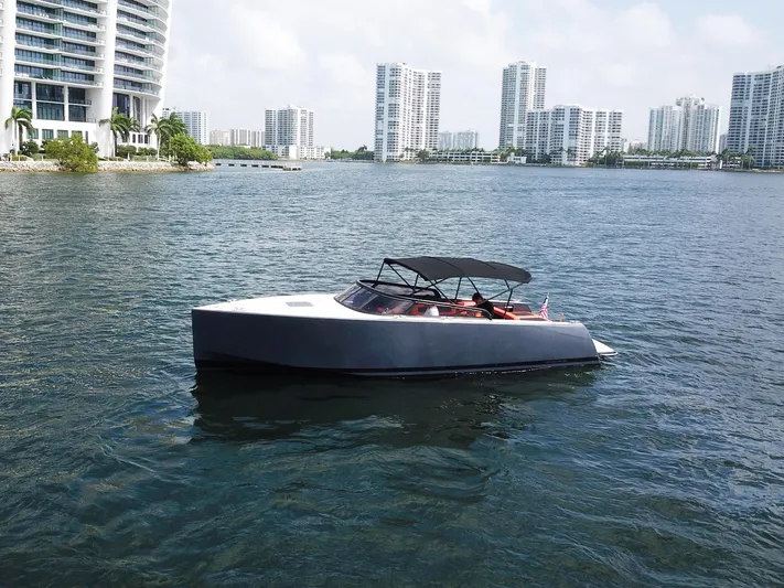  Yacht Photos Pics 2016 VanDutch 30 yacht cruising near modern waterfront buildings.