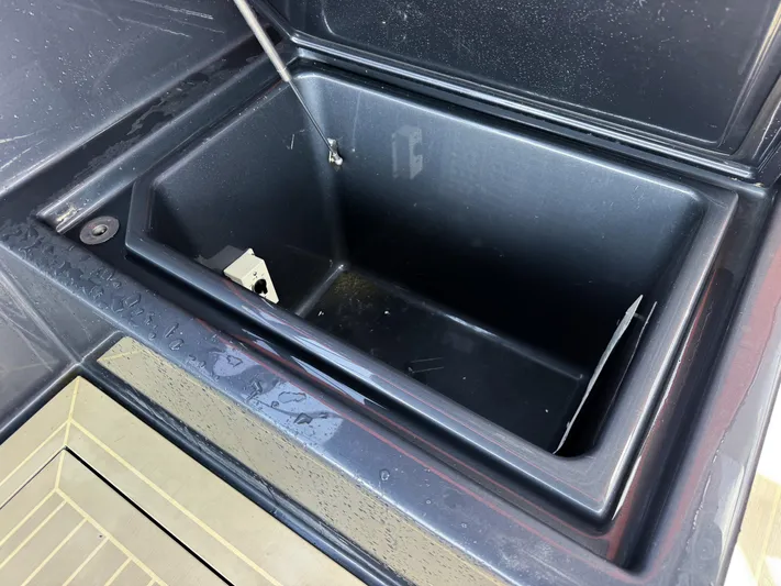  Yacht Photos Pics Open storage compartment on a 2016 VanDutch 30 boat, showing interior details.