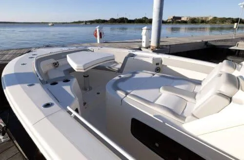  Yacht Photos Pics 2026 Scout 357 LXF boat docked by serene waters, showcasing luxurious seating and sleek design.