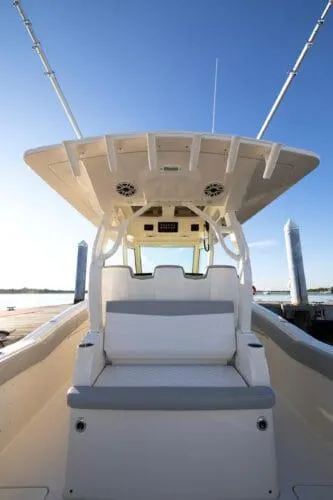  Yacht Photos Pics 2026 Scout 357 LXF boat interior with seating and helm, under clear blue sky.