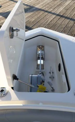  Yacht Photos Pics 2026 Scout 357 LXF boat anchor compartment with open hatch on wooden dock.