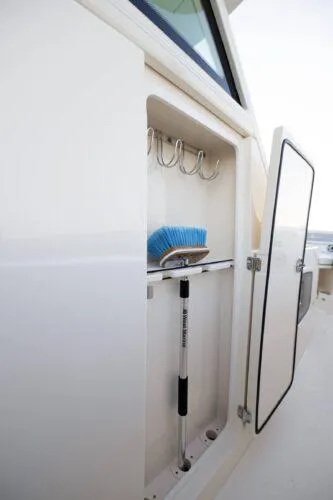  Yacht Photos Pics 2026 Scout 357 LXF storage compartment with hooks and cleaning tools.
