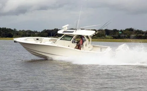  Yacht Photos Pics 2026 Scout 357 LXF boat cruising on water, showcasing sleek design and powerful performance.