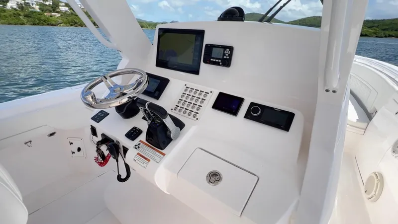  Yacht Photos Pics 2020 Intrepid 345 Nomad boat dashboard with steering wheel and navigation controls.