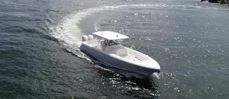  Yacht Photos Pics 2020 Intrepid 345 Nomad boat cruising on open water, creating a gentle wake.