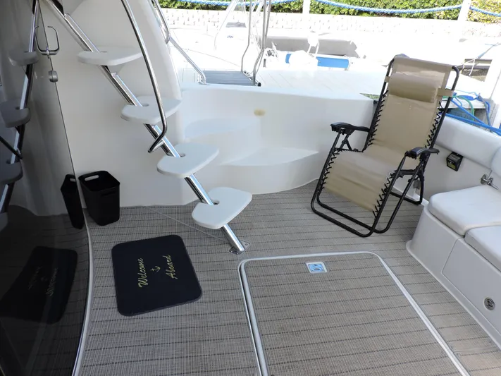  Yacht Photos Pics 2010 Carver 56 Voyager SE yacht deck with chair and stairs.