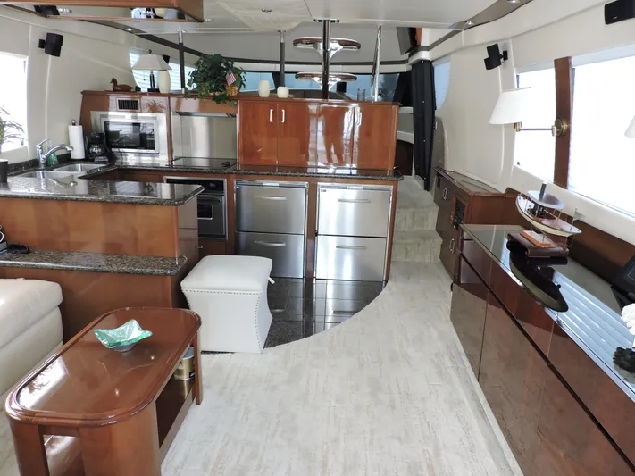  Yacht Photos Pics Luxurious interior of 2010 Carver 56 Voyager SE yacht with modern kitchen and elegant wood finishes.