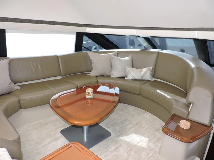  Yacht Photos Pics Luxurious interior of 2010 Carver 56 Voyager SE yacht with curved leather seating and wooden table.