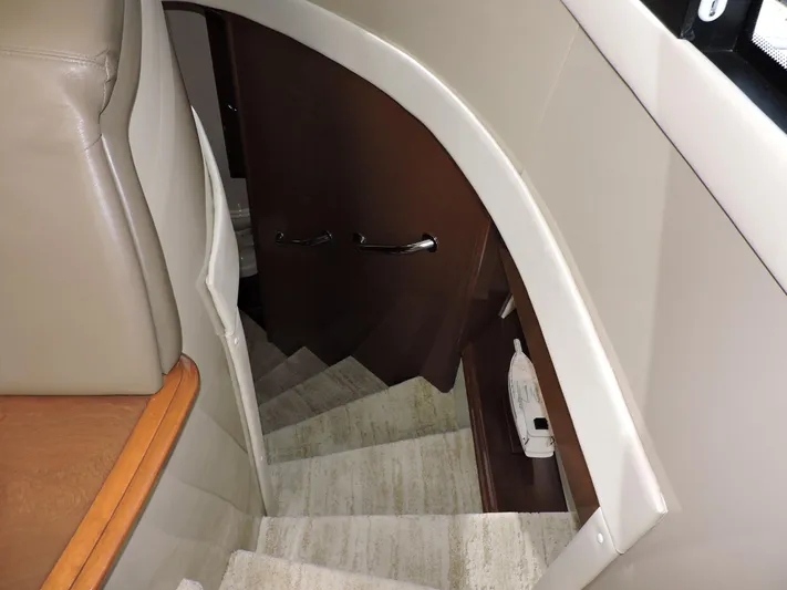  Yacht Photos Pics Staircase inside 2010 Carver 56 Voyager SE yacht, featuring elegant wood and carpet design.