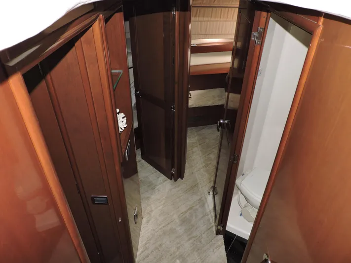  Yacht Photos Pics Interior of 2010 Carver 56 Voyager SE yacht, featuring wooden doors and a compact bathroom.