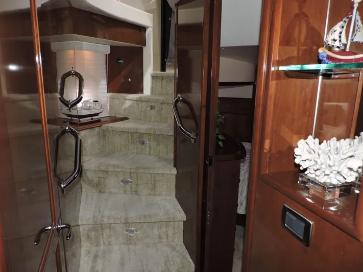  Yacht Photos Pics Interior staircase of 2010 Carver 56 Voyager SE yacht, featuring elegant wood and decor.