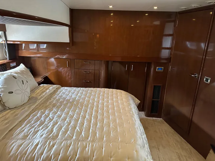  Yacht Photos Pics Luxurious bedroom interior of 2010 Carver 56 Voyager SE yacht with wood paneling.