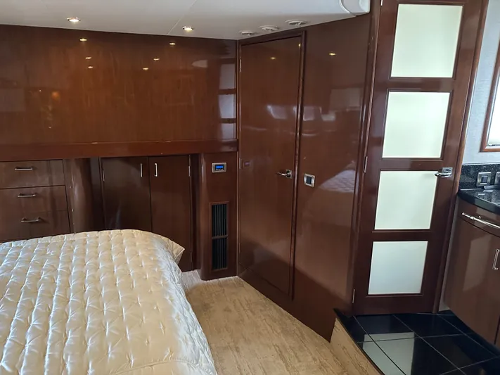  Yacht Photos Pics Luxurious interior of 2010 Carver 56 Voyager SE yacht with wood paneling and plush bedding.