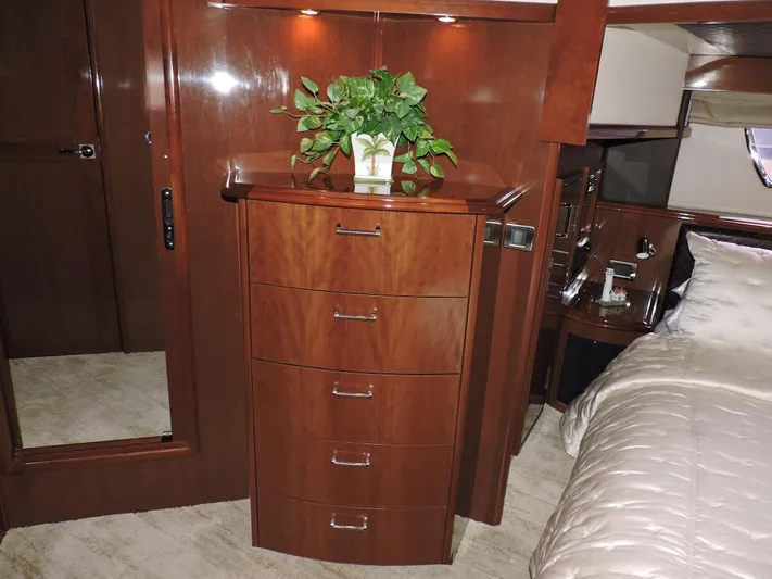  Yacht Photos Pics Luxurious 2010 Carver 56 Voyager SE bedroom with wooden dresser and elegant bedding.
