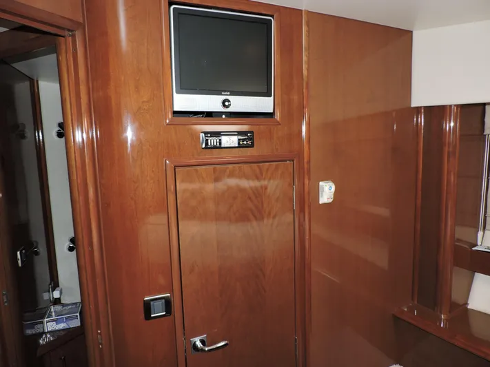  Yacht Photos Pics Interior of 2010 Carver 56 Voyager SE with wood paneling and mounted TV.
