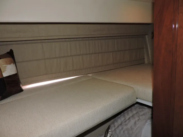  Yacht Photos Pics 2010 Carver 56 Voyager SE interior cabin with beige bedding and wooden accents.