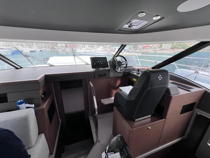  Yacht Photos Pics Interior view of 2024 Beneteau M 48 yacht cockpit with modern controls and seating.