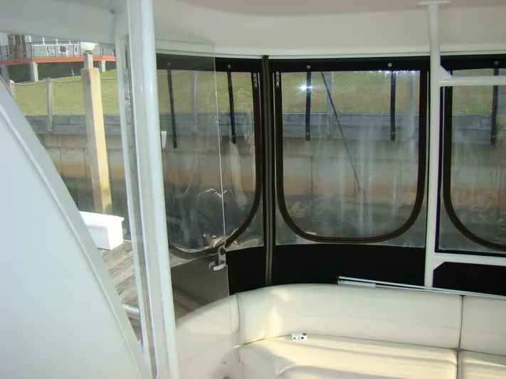 Cramitall Inn Yacht Photos Pics 2004 Cruisers 455 Express Motoryacht interior with white seating and clear windows.