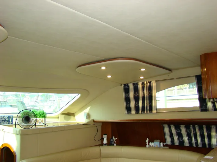 Cramitall Inn Yacht Photos Pics Interior of 2004 Cruisers 455 Express Motoryacht with beige seating and striped curtains.