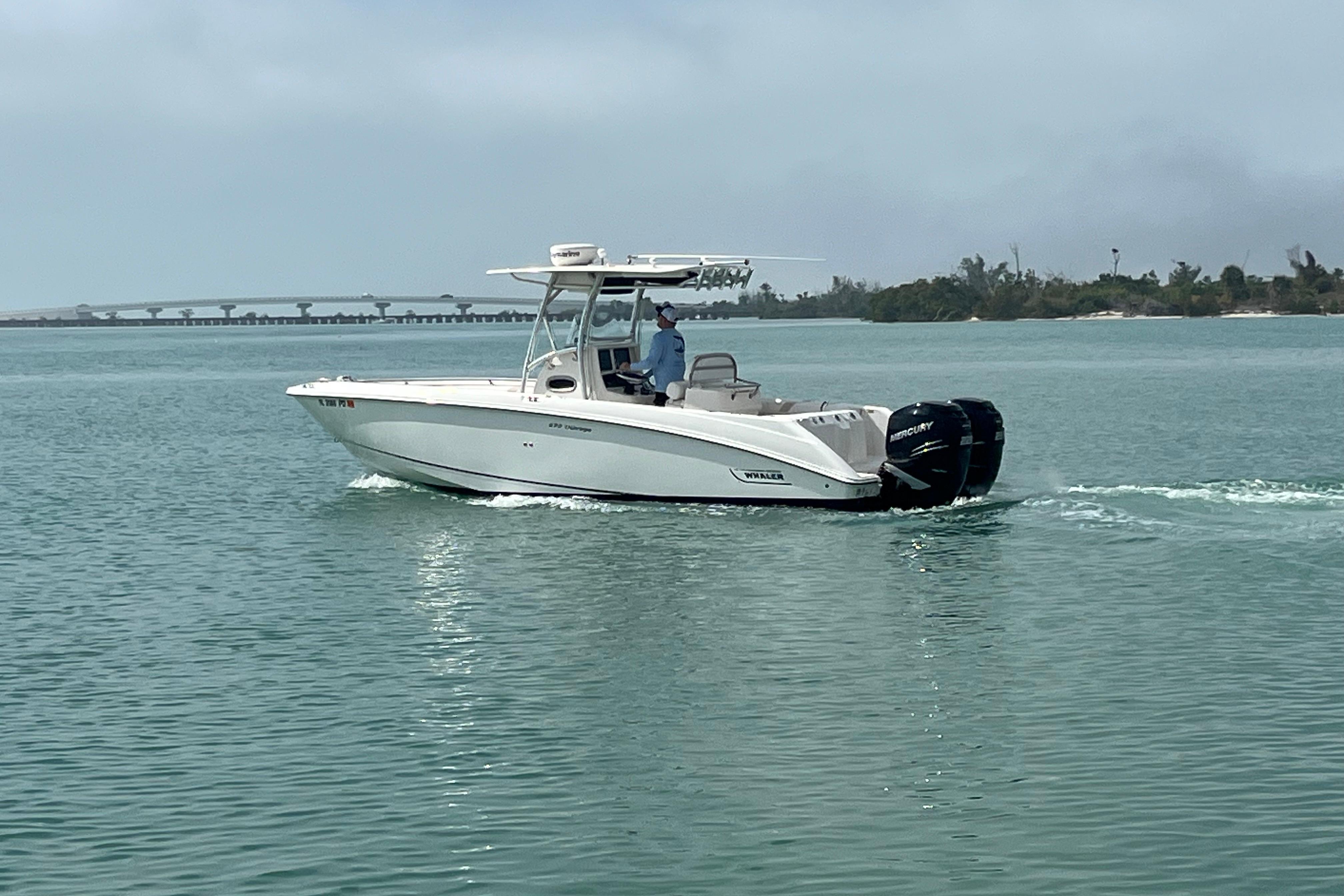 2007 Boston Whaler 270 Outrage boat cruising on calm waters.