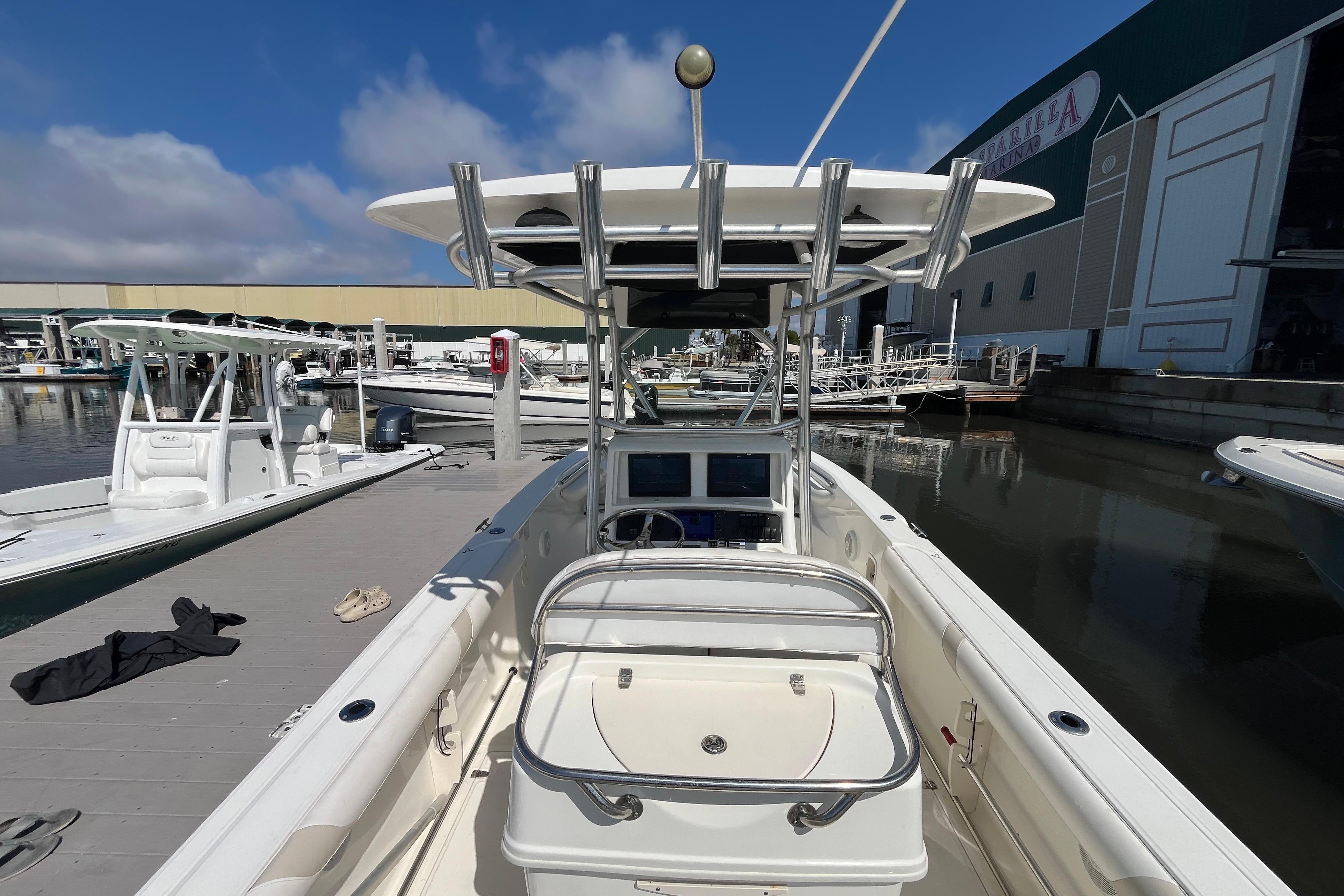 2007 Boston Whaler 270 Outrage boat docked at marina under clear blue sky.