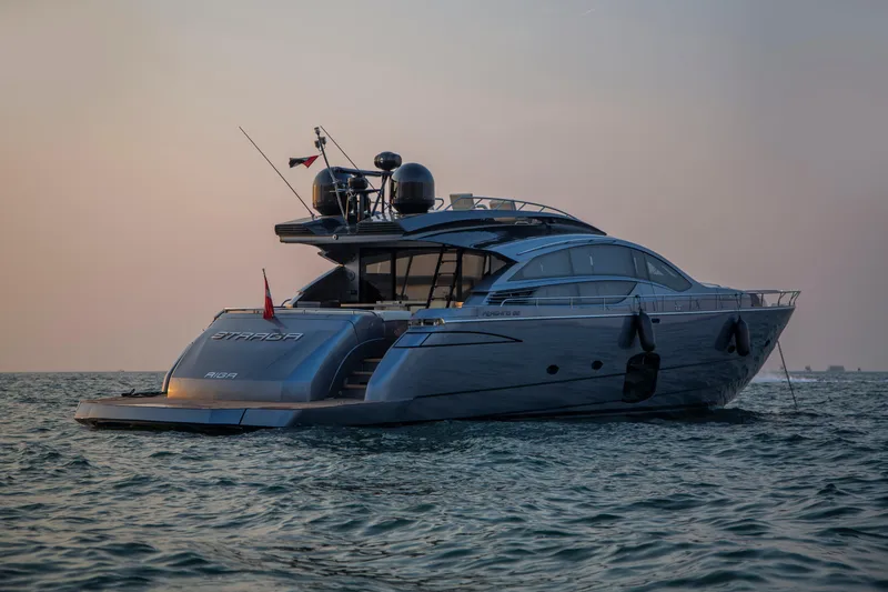  Yacht Photos Pics Luxurious 2016 Pershing 82 yacht cruising at sunset on calm waters.