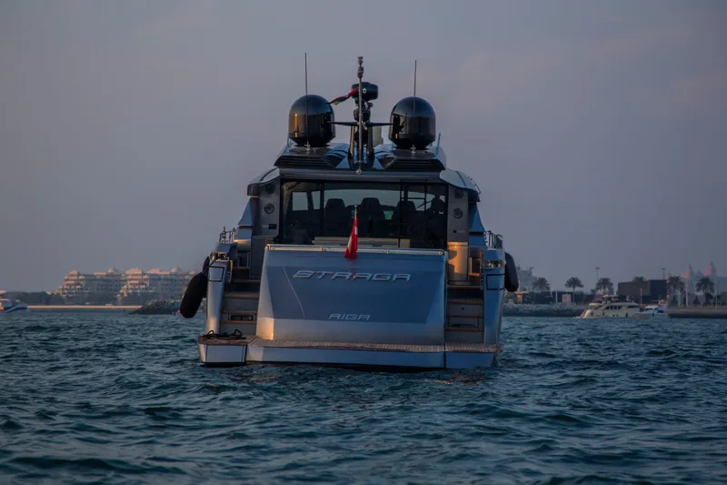  Yacht Photos Pics 2016 Pershing 82 yacht on water at sunset, cityscape in background.