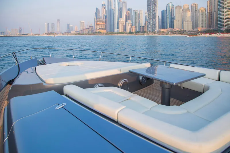  Yacht Photos Pics Luxurious 2016 Pershing 82 yacht with elegant seating, city skyline in background.