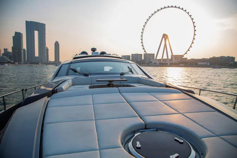  Yacht Photos Pics 2016 Pershing 82 yacht cruising near city skyline and Ferris wheel at sunset.