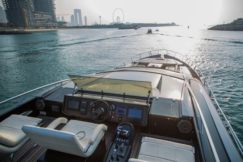  Yacht Photos Pics Luxurious 2016 Pershing 82 yacht cruising in scenic waters near a modern cityscape.