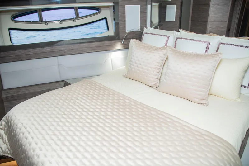  Yacht Photos Pics Luxurious bedroom interior on 2016 Pershing 82 yacht with elegant bedding and ocean view.