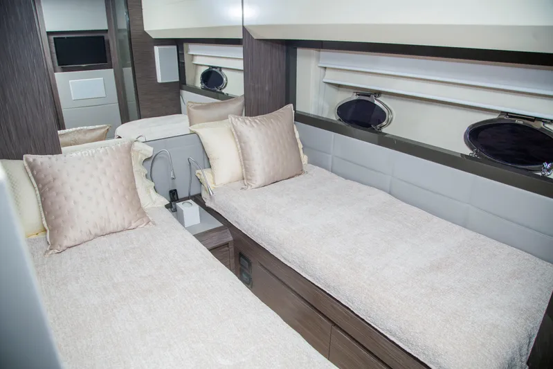  Yacht Photos Pics Luxurious twin cabin interior of 2016 Pershing 82 yacht with elegant bedding and decor.