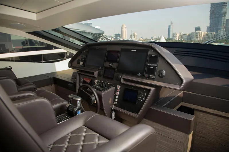  Yacht Photos Pics Luxurious interior of a 2016 Pershing 82 yacht cockpit with modern navigation equipment.