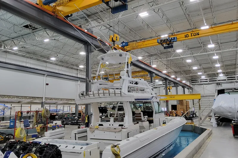  Yacht Photos Pics 2026 Formula 457 Center Console Fish boat in a manufacturing facility with overhead cranes.