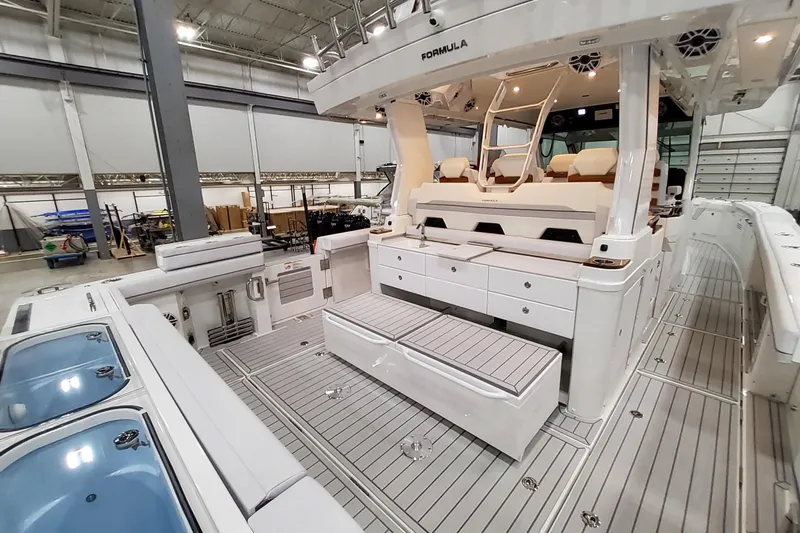  Yacht Photos Pics 2026 Formula 457 Center Console Fish boat interior with seating and storage in a showroom.