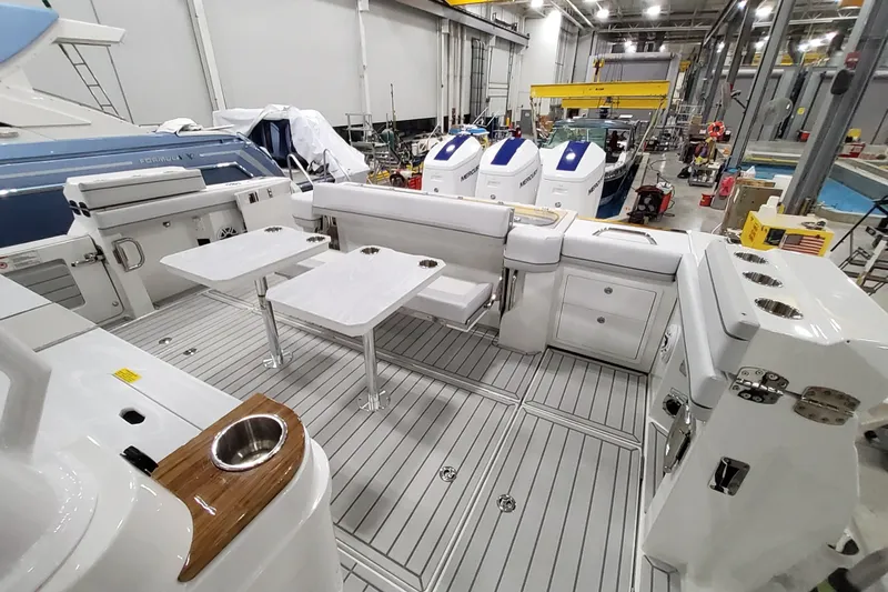  Yacht Photos Pics 2026 Formula 457 Center Console Fish boat interior with seating and tables in a workshop.