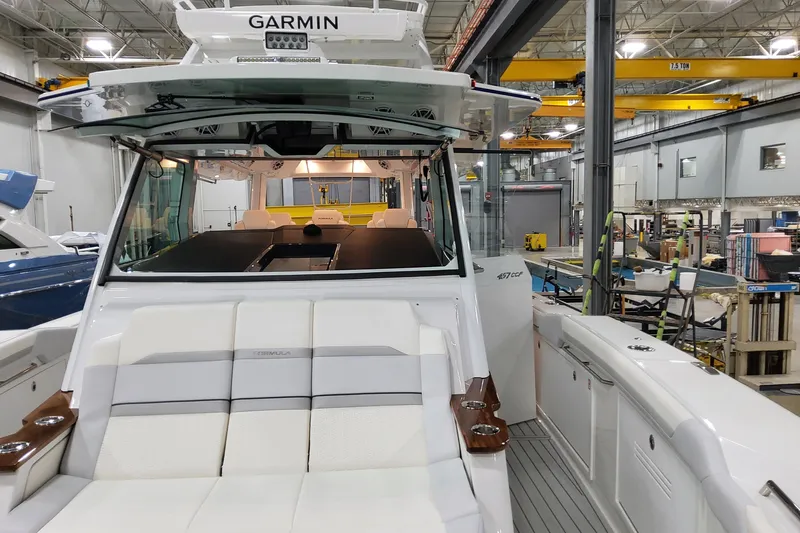  Yacht Photos Pics 2026 Formula 457 Center Console Fish boat in a workshop, featuring Garmin equipment.